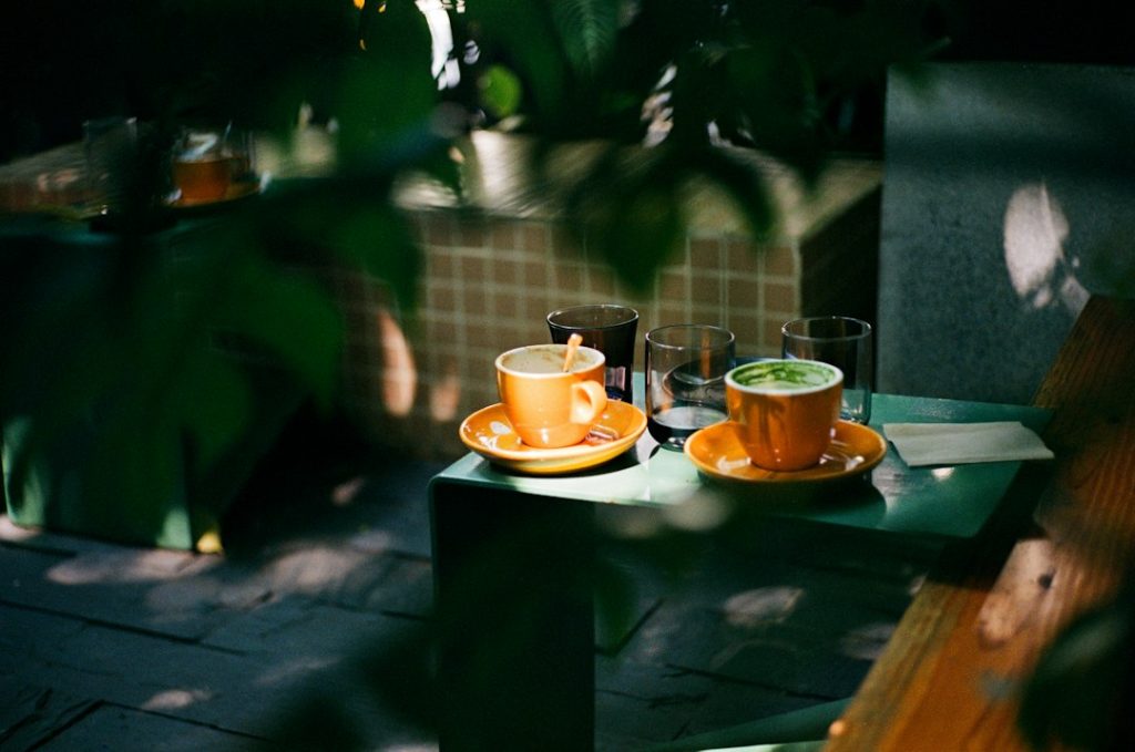 Two warm-toned coffee cups on a table